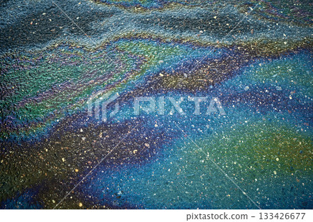 Oil spill creating vibrant iridescent rainbow colors on asphalt Oil spill creating vibrant iridescent rainbow colors on asphalt 133426677