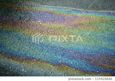 Iridescent oil spill creating rainbow colors on asphalt Iridescent oil spill creating rainbow colors on asphalt 133426680
