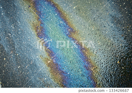 Oil Slick Reflects Light on Wet Pavement, Showcasing Vibrant Colors in an Urban Environment After Rain Oil Slick Reflects Light on Wet Pavement, Showcasing Vibrant Colors in an Urban Environment After Rain 133426687