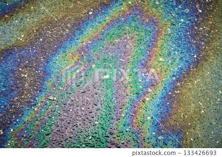 Oil slick spreading on a wet asphalt surface, showing a psychedelic pattern Oil slick spreading on a wet asphalt surface, showing a psychedelic pattern 133426693