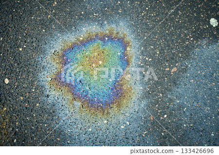Colorful fuel spill showcasing bright colors that create a unique abstract texture on wet pavement. 133426696