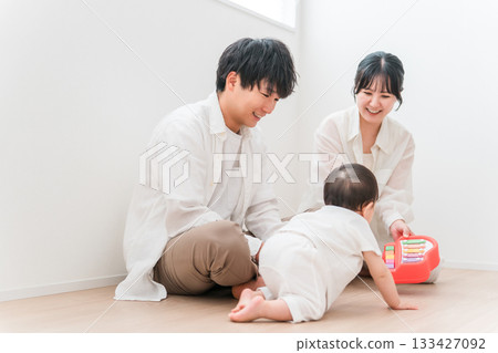 Parents and children playing with their babies in the living room, family, couple 133427092