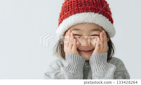 Child wearing a Santa hat Child wearing a Santa hat 133428264