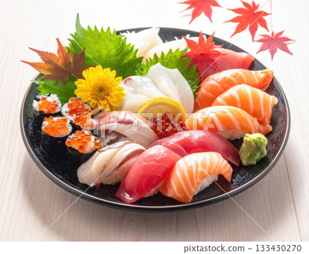 Assorted nigiri sushi decorated with autumn leaves - seasonal flavors 133430270