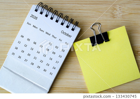 Top view of October 2026 Calendar with blank sticky note with customizable space for text or message. 133430745