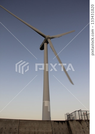 Wind turbines illuminated by the setting sun Wind turbines illuminated by the setting sun 133431820