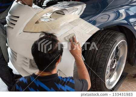 Checking car body work fiber bumper at car garage Checking car body work fiber bumper at car garage 133431983
