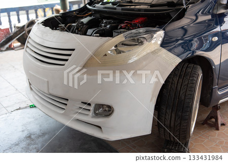 Checking car body work fiber bumper at car garage 133431984