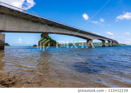 The Kouri Bridge in Okinawa spans the blue sea, connecting Kouri Island. The Kouri Bridge in Okinawa spans the blue sea, connecting Kouri Island. 133432239