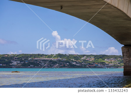 The Kouri Bridge in Okinawa spans the blue sea, connecting Kouri Island. 133432243