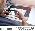 Man taking photo of homemade bread dough. 133433386