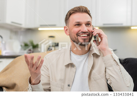 Young man talks with friend on smartphone gestures explains decision then warm goodbye friendly call Young man talks with friend on smartphone gestures explains decision then warm goodbye friendly call 133433841