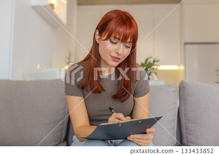 Young woman draws on paper makes sketch logo or illustration for work creative design process step 133433852