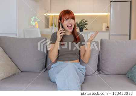 Young woman argues on smartphone frowns quick gestures says what why angry debate heated talk mood Young woman argues on smartphone frowns quick gestures says what why angry debate heated talk mood 133433853