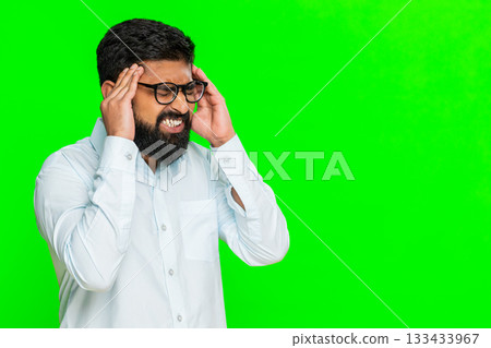 Indian man touching head with hand showing stress pain or emotional suffering moment of worry 133433967