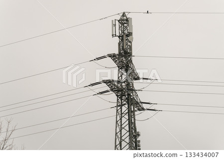 high voltage pole with power line 133434007