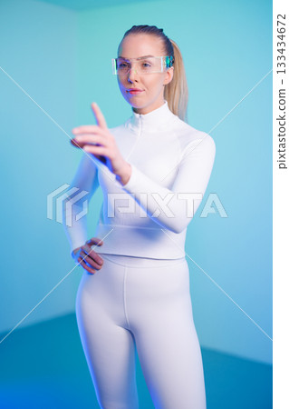 Female in smartglasses against blue background 133434672