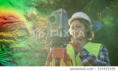 A female surveyor uses lidar technology for ultra-precise measurements and calculations in civil engineering. This involves the use of laser scanning technology to create highly accurate aerial A female surveyor uses lidar technology for ultra-precise measurements and calculations in civil engineering. This involves the use of laser scanning technology to create highly accurate aerial 133435436