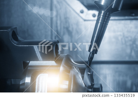 The 5-axis CNC milling machine cutting the automotive part with solid ball nose end mill tool with lighting effect. 133435519