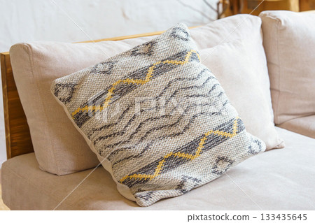 Cozy textured pillow, decorative cushion with geometric pattern on beige sofa, natural home interior Cozy textured pillow, decorative cushion with geometric pattern on beige sofa, natural home interior 133435645