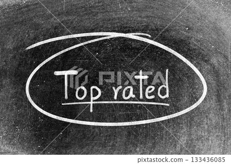 White chalk hand writing in word top rated and circle shape on blackboard background 133436085