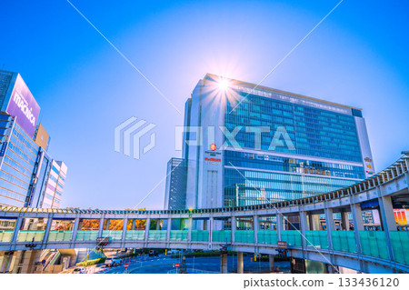 Yokohama cityscape in Japan. View of Yokohama Station, the north exit of JR Shin-Yokohama Station, and the circular footbridge over Yokohama Loop Line 2. A ray of hope. Yokohama cityscape in Japan. View of Yokohama Station, the north exit of JR Shin-Yokohama Station, and the circular footbridge over Yokohama Loop Line 2. A ray of hope. 133436120