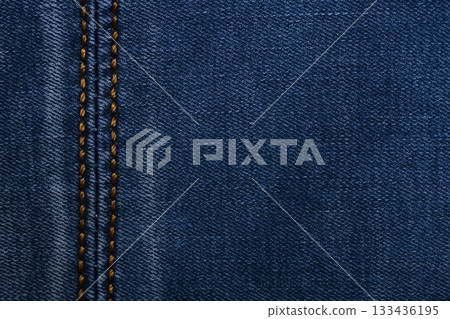 Denim fabric with yellow thread seams, denim jacket, denim pants, for background or fabric sample sale. 133436195