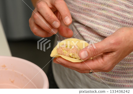 Crafting savory dumplings in a cozy kitchen as the sun sets Crafting savory dumplings in a cozy kitchen as the sun sets 133436242