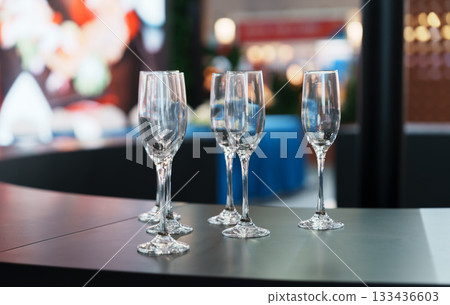 Empty champagne glasses arranged on the bar 133436603