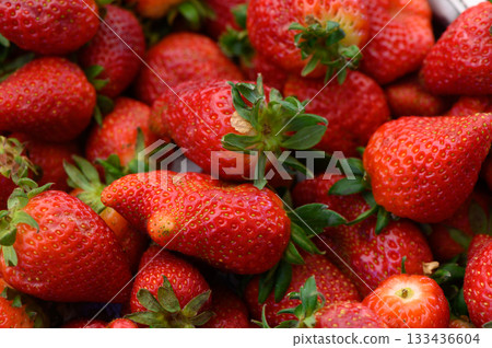 Fresh strawberries glisten under the sunlight at a local market in summer, inviting taste and joy on a sunny afternoon Fresh strawberries glisten under the sunlight at a local market in summer, inviting taste and joy on a sunny afternoon 133436604