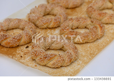 Delightful sesame rings baked to perfection at a sunny bakery in the heart of the city Delightful sesame rings baked to perfection at a sunny bakery in the heart of the city 133436691