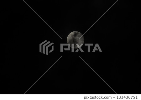 Full moon shining brightly in the cloudless night sky. 133436751