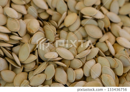 Harvesting pumpkin seeds for autumn celebrations and seasonal festivities in a cozy kitchen setting 133436756