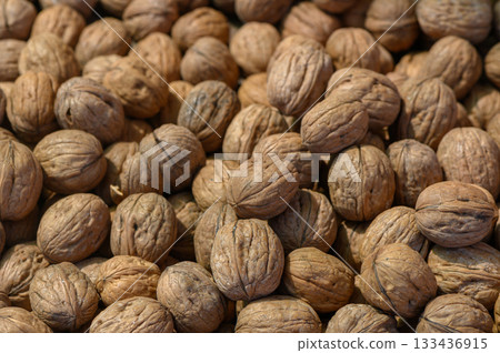Harvested walnuts ready for market display in a rustic farmers market setting during autumn Harvested walnuts ready for market display in a rustic farmers market setting during autumn 133436915