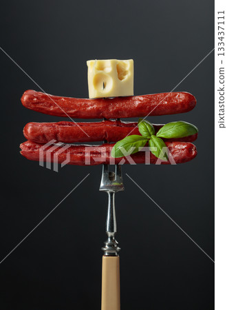 Grilled sausages with cheese and basil. 133437111
