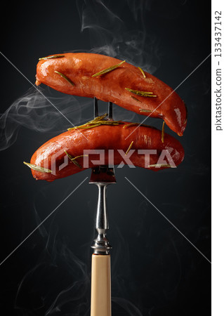 Roasted Bavarian sausages with rosemary. 133437142