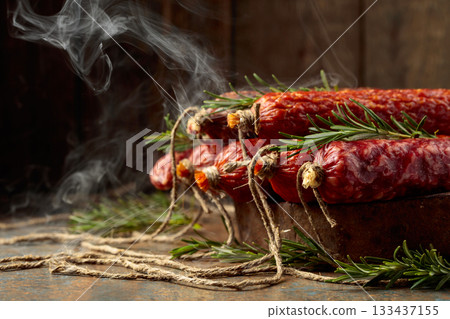 Smoked and dry cured sausages on a rustic background. 133437155
