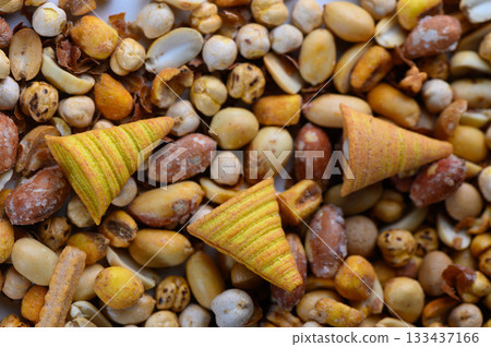 Colorful crunchy treats mixed with an assortment of nuts and seeds create a vibrant snack medley on a sunny afternoon 133437166