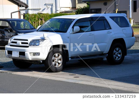 Passenger cars lined up in a parking lot (Toyota Hilux Surf 4th generation) 133437259