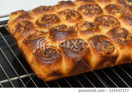 Baking a delicious homemade bread with a golden crust and sweet filling fresh out of the oven, perfect for any gathering or family meal Baking a delicious homemade bread with a golden crust and sweet filling fresh out of the oven, perfect for any gathering or family meal 133437377
