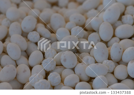 White candies scattered on a textured surface during a festive event in a cozy setting White candies scattered on a textured surface during a festive event in a cozy setting 133437388
