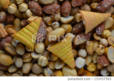 Crunchy snacks spread out on a colorful assortment of nuts perfect for sharing during festive gatherings 133437563