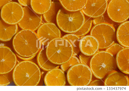 Bright citrus slices create a vibrant display of freshness and color in a summer kitchen setting Bright citrus slices create a vibrant display of freshness and color in a summer kitchen setting 133437974