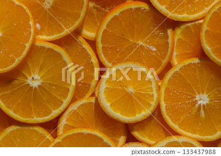 Freshly sliced oranges create a vibrant and zesty display, perfect for summer refreshment and culinary delights Freshly sliced oranges create a vibrant and zesty display, perfect for summer refreshment and culinary delights 133437988