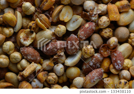 Colorful assortment of roasted nuts and seeds creating a vibrant mosaic of textures and flavors in a casual dining atmosphere 133438110