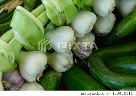 Freshly harvested vegetables showcase vibrant green hues and crisp textures at a bustling farmers market in the early morning light 133438111