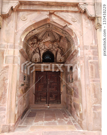 Ancient stone lattice window with intricate carving in historic architecture, showcasing detailed craftsmanship and traditional stonework design in heritage building, cultural art of India Ancient stone lattice window with intricate carving in historic architecture, showcasing detailed craftsmanship and traditional stonework design in heritage building, cultural art of India 133438229