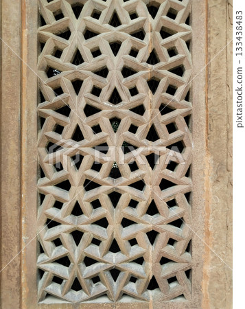 Intricate Stone Lattice Window (Jali) Featuring Traditional Mughal Architecture and Carved Geometric Patterns in Historic Indian Monument Intricate Stone Lattice Window (Jali) Featuring Traditional Mughal Architecture and Carved Geometric Patterns in Historic Indian Monument 133438483