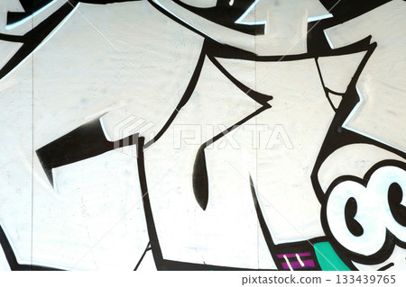 Colorful background of graffiti painting artwork with bright aerosol outlines on wall. Old school street art piece made with aerosol spray paint cans. Contemporary youth culture backdrop 133439765