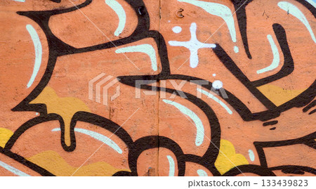 Colorful background of graffiti painting artwork with bright aerosol outlines on wall. Old school street art piece made with aerosol spray paint cans. Contemporary youth culture backdrop 133439823